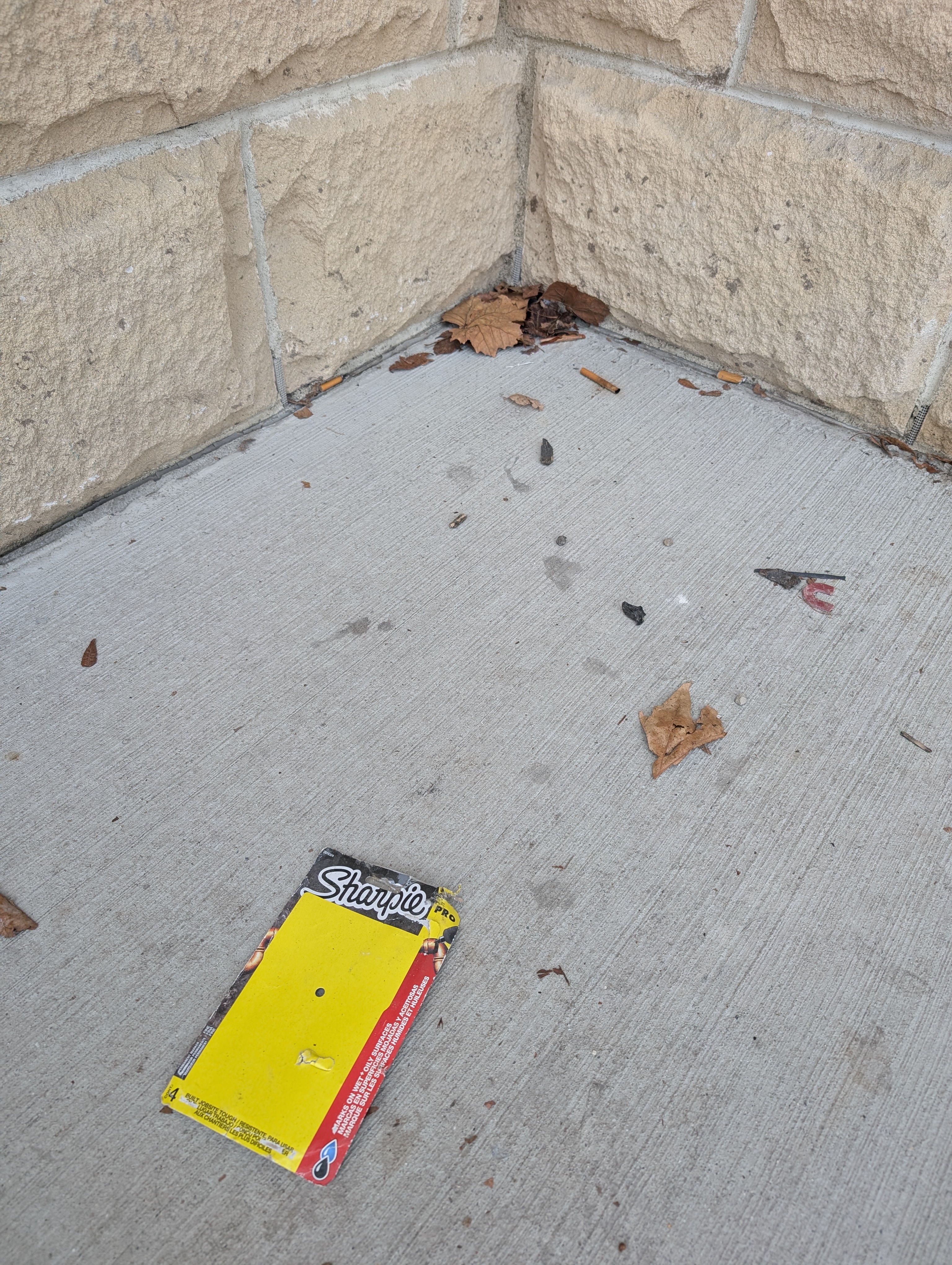 Trash and debris collected in a building corner
