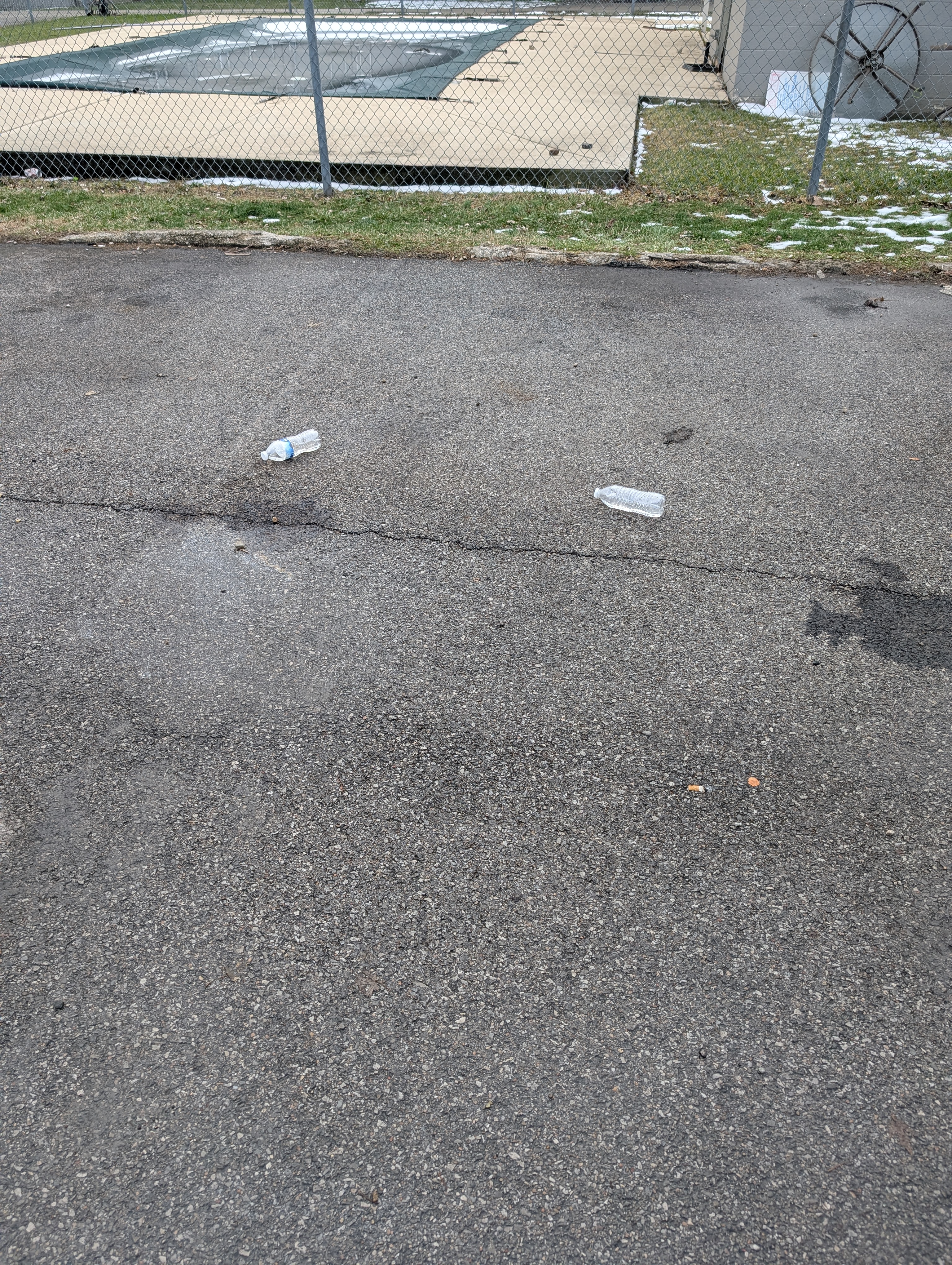 Litter and debris on a commercial parking lot surface